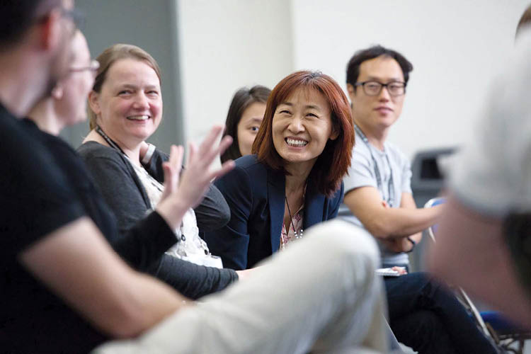 Four annual meeting attendees conversing