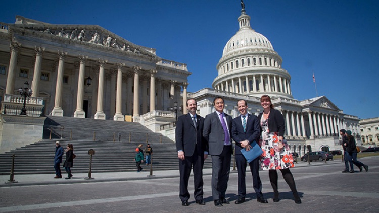 Advocates pose in front of the US Capitol