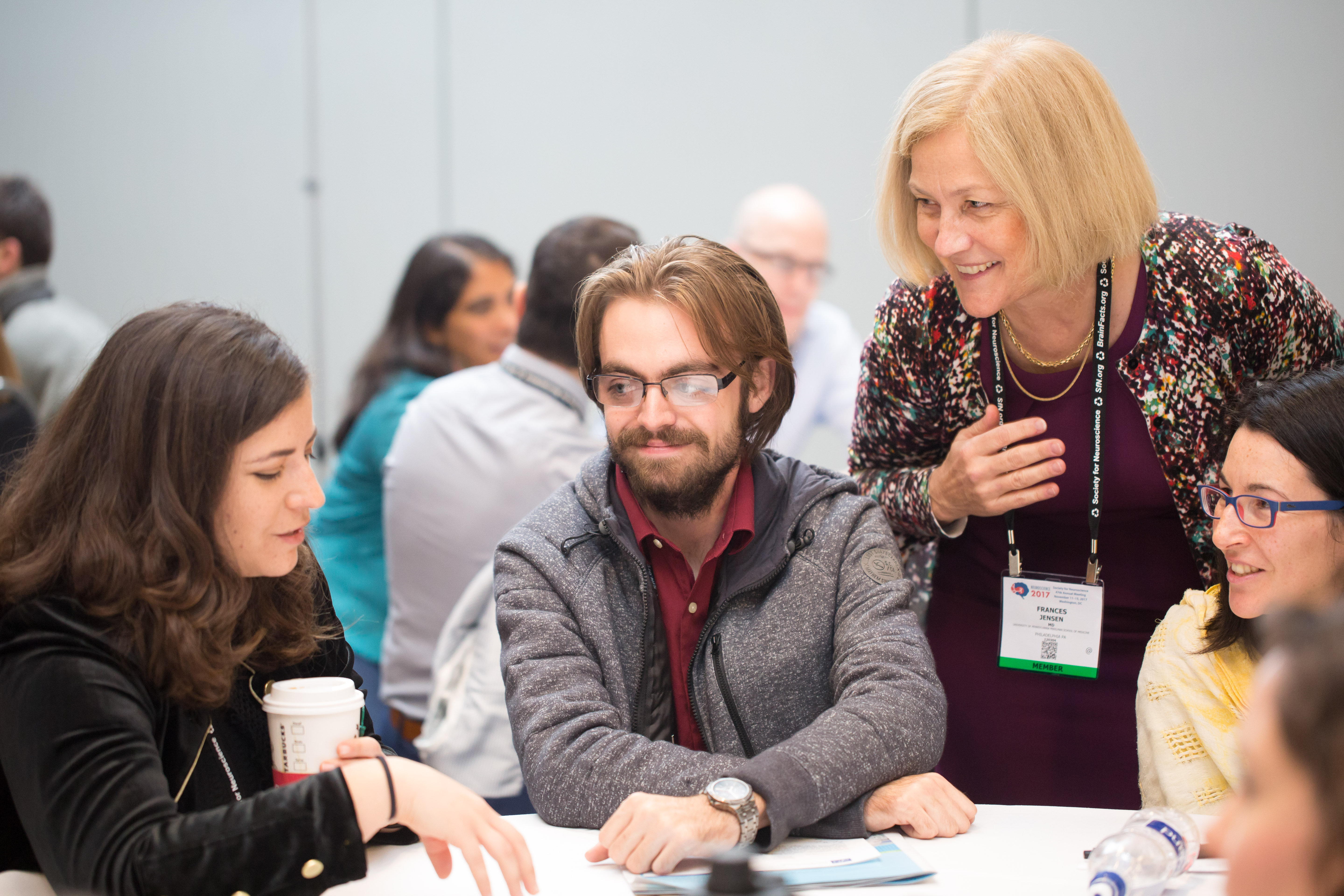 annual meeting attendees gathered around a table