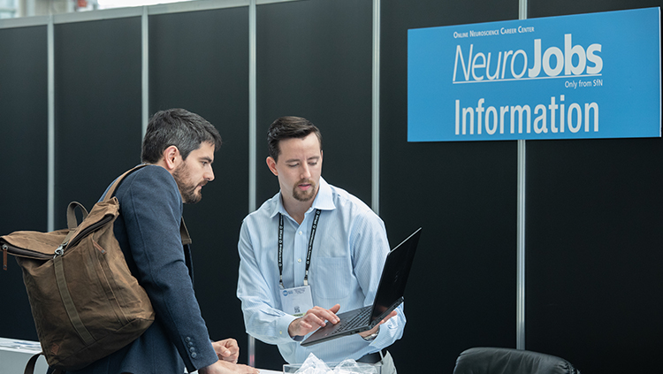 Two people at the NeuroJobs information booth