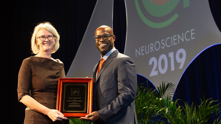 Kafui Dzirasa, MD, PhD (right), of Duke University, receives the Young Investigator Award
