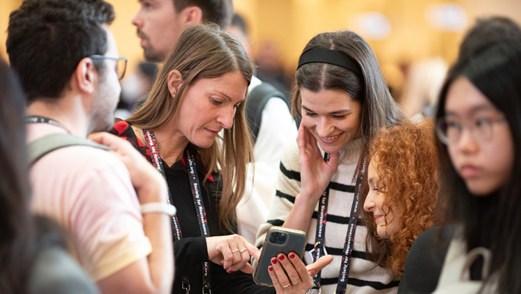 Neuroscience 2025 attendees looking at their phones
