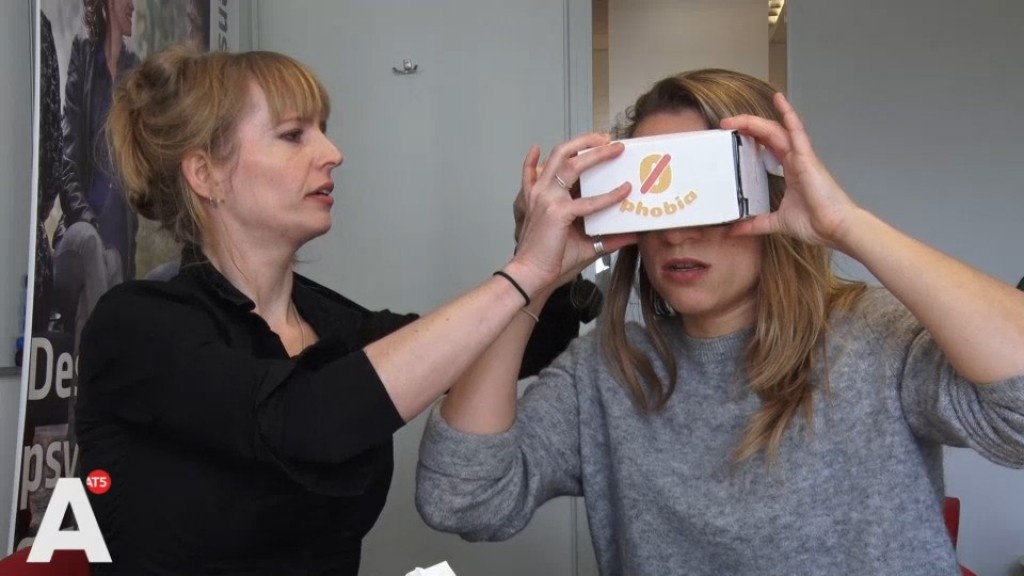  Tara Donker, left, fits a patient with ZeroPhobia’s virtual reality goggles for the treatment of the fear of heights. Donker is completeing research into the effectivenes of ZeroPhobia for the fear of flying. 