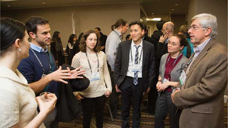 Image of several scientists gathered at a networking event.